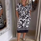 Elegant kjole med V-hals, vintageprint og lommer