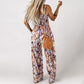 ✨ 50 % RABATT NÅ! 🌼 Blomstret, ermeløs jumpsuit for damer – smocket brystparti og vide ben – sommerlig chic 👒�