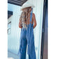 V-hals, ermeløs, sexy jumpsuit i vasket denim med åpen rygg